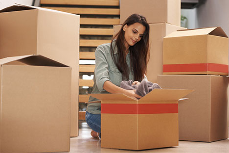 woman unpacking clothes from a box