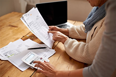 woman looking at bill papers