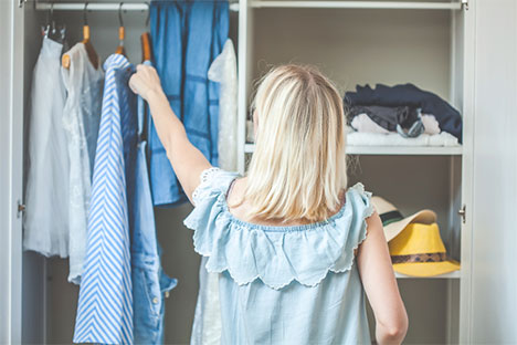 woman looking at clothes in a closet