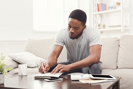 man writing on paper